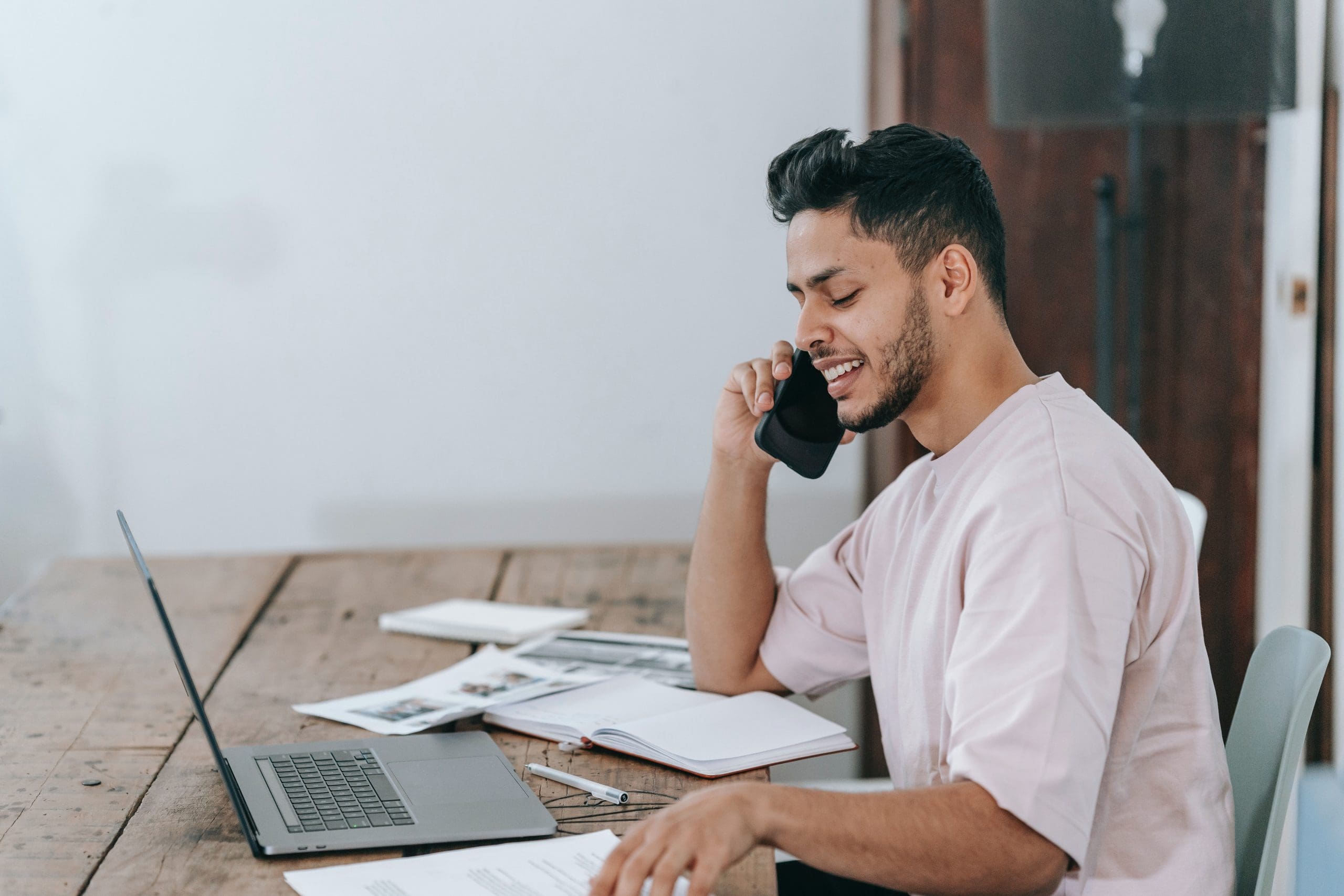 Man Speaking On The Phone At Workplace