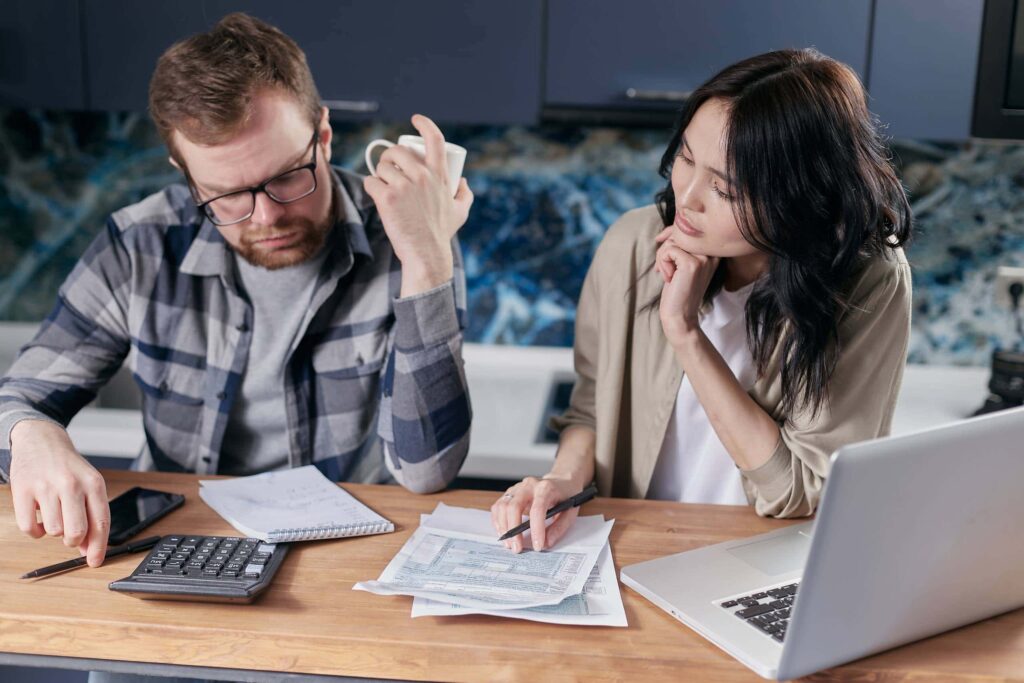 man and woman looking over bankruptcy paperwork