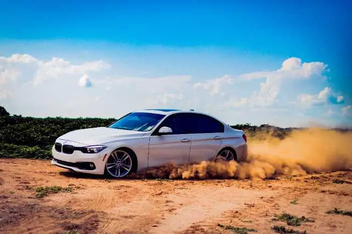 car drifting on dirt road