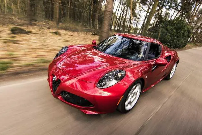 red sports car driving fast on a road