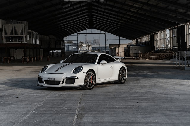 white car parked on pavement